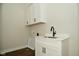 Laundry room with utility sink, white cabinets and flooring at 2749 Stones Bay Dr, Greenwood, IN 46143