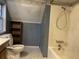 Small bathroom with shower/tub, toilet, and a small wooden shelf at 5212 W 300 N, Greenfield, IN 46140