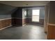 Empty bedroom with wood paneled walls, a window and gray floors at 5212 W 300 N, Greenfield, IN 46140