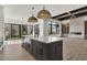 Open concept kitchen with island, white quartz countertops, and black cabinetry at 9280 Highpointe Ln, Zionsville, IN 46077