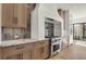 Modern kitchen with light wood cabinets, marble countertops, and high-end appliances at 9280 Highpointe Ln, Zionsville, IN 46077