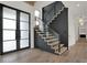 Modern staircase with glass railing and dark wood feature wall at 9280 Highpointe Ln, Zionsville, IN 46077
