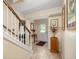 Bright entryway with tile flooring, wooden staircase, and decorative accents at 4501 N Wheeling Ave # 3-106, Muncie, IN 47304