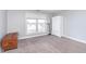 Bright bedroom with a large window, carpet flooring, and ample closet space at 8751 Jaffa Court E Dr # 35, Indianapolis, IN 46260