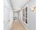 Bright hallway with tile floor, white doors, and built-in shelving at 8751 Jaffa Court E Dr # 35, Indianapolis, IN 46260