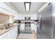 Modern kitchen with white cabinets, granite counters, and stainless steel appliances at 8751 Jaffa Court E Dr # 35, Indianapolis, IN 46260