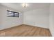 Simple bedroom with wood-look flooring and a large window at 679 E 16Th St, Indianapolis, IN 46202