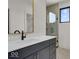 Modern bathroom with a glass shower, dark vanity, and white countertop at 679 E 16Th St, Indianapolis, IN 46202