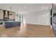 Spacious kitchen with island, stainless steel appliances, and hardwood floors at 679 E 16Th St, Indianapolis, IN 46202