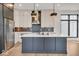Modern kitchen with island, stainless steel appliances, and hardwood floors at 679 E 16Th St, Indianapolis, IN 46202