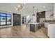 Open concept kitchen with island, stainless steel appliances, and hardwood floors at 679 E 16Th St, Indianapolis, IN 46202