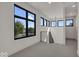 Spacious loft area with multiple windows and a modern light fixture at 679 E 16Th St, Indianapolis, IN 46202