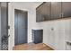 Functional laundry room with dark cabinets and wood-look flooring at 679 E 16Th St, Indianapolis, IN 46202