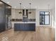 Modern kitchen with an island, stainless steel appliances, and hardwood floors at 679 E 16Th St, Indianapolis, IN 46202