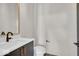 Modern powder room with dark vanity and gold fixtures at 679 E 16Th St, Indianapolis, IN 46202