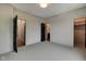 Simple bedroom with carpet, and access to a bathroom and closet at 721 E 16Th St, Indianapolis, IN 46202