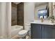 Modern bathroom with dark tile and updated vanity at 721 E 16Th St, Indianapolis, IN 46202