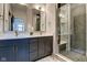 Modern bathroom with double vanity, a large shower, and gold fixtures at 721 E 16Th St, Indianapolis, IN 46202