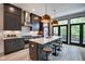 Modern kitchen with dark cabinetry, quartz countertops, and stainless steel appliances at 721 E 16Th St, Indianapolis, IN 46202