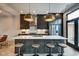 Modern kitchen with dark cabinetry, quartz countertops, and stainless steel appliances at 721 E 16Th St, Indianapolis, IN 46202