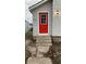 House exterior featuring a red front door and concrete steps at 1207 W 10Th St, Anderson, IN 46016