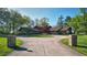 Brick ranch home with circular driveway and mature trees at 8494 W Mulligan Ln, Columbus, IN 47201