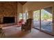 Living room with patio access, comfortable seating, and brick fireplace at 8494 W Mulligan Ln, Columbus, IN 47201