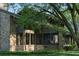 Brick home with a screened porch and mature landscaping at 8494 W Mulligan Ln, Columbus, IN 47201