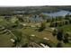 Aerial view of a golf course community with lake and lush green landscape at 8494 W Mulligan Ln, Columbus, IN 47201