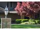 Brick entrance with lamp post and red tree adding curb appeal at 8494 W Mulligan Ln, Columbus, IN 47201