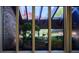 View from inside showing a lush garden through a multi-paned window at 8494 W Mulligan Ln, Columbus, IN 47201