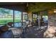 Sunroom with wicker furniture and view of golf course at 8494 W Mulligan Ln, Columbus, IN 47201