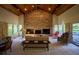 Living room with large brick fireplace and view to backyard at 8494 W Mulligan Ln, Columbus, IN 47201