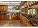 Modern kitchen with granite countertops and wood cabinets at 8494 W Mulligan Ln, Columbus, IN 47201