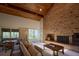 Spacious living room features a brick fireplace, vaulted ceiling, and large windows with scenic views at 8494 W Mulligan Ln, Columbus, IN 47201