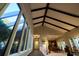 Bright living room with vaulted ceiling and wall of windows offering abundant natural light at 8494 W Mulligan Ln, Columbus, IN 47201