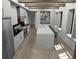 Modern kitchen with a large island, white cabinets, and marble countertops at 723 N Cleveland St, Indianapolis, IN 46202