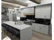 Modern kitchen with a large island, white cabinets, and marble countertops at 723 N Cleveland St, Indianapolis, IN 46202