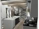 Modern kitchen with a large island, white cabinets, and marble countertops at 723 N Cleveland St, Indianapolis, IN 46202