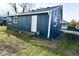 Blue house exterior with white trim and a side entrance at 1431 E Pleasant Run Parkway South Dr, Indianapolis, IN 46203
