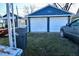 Detached two-car garage with white doors and blue exterior at 1431 E Pleasant Run Parkway South Dr, Indianapolis, IN 46203