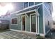 Modern back patio with gray square tiles and a view of a back door at 2133 N Talbott St, Indianapolis, IN 46202