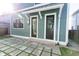 Modern back patio with gray square tiles and a view of a back door at 2133 N Talbott St, Indianapolis, IN 46202