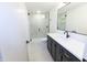 Modern basement bathroom with a walk-in shower and dark vanity at 2133 N Talbott St, Indianapolis, IN 46202