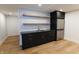 Basement wet bar with dark cabinetry and granite countertop at 2133 N Talbott St, Indianapolis, IN 46202