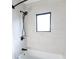 Bathroom with a shower/tub combo and light grey tile at 2133 N Talbott St, Indianapolis, IN 46202