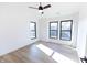 Bright bedroom with wood-look floors and three large windows at 2133 N Talbott St, Indianapolis, IN 46202