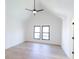 Spacious bedroom with vaulted ceilings, wood floors, and two windows at 2133 N Talbott St, Indianapolis, IN 46202