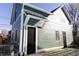 Back exterior of teal home featuring a black door and metal awning at 2133 N Talbott St, Indianapolis, IN 46202