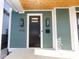 Modern black front door with glass panel and stylish light fixtures at 2133 N Talbott St, Indianapolis, IN 46202